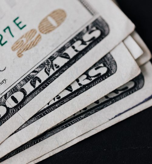 pile-of-american-paper-money-on-black-surface-4386379